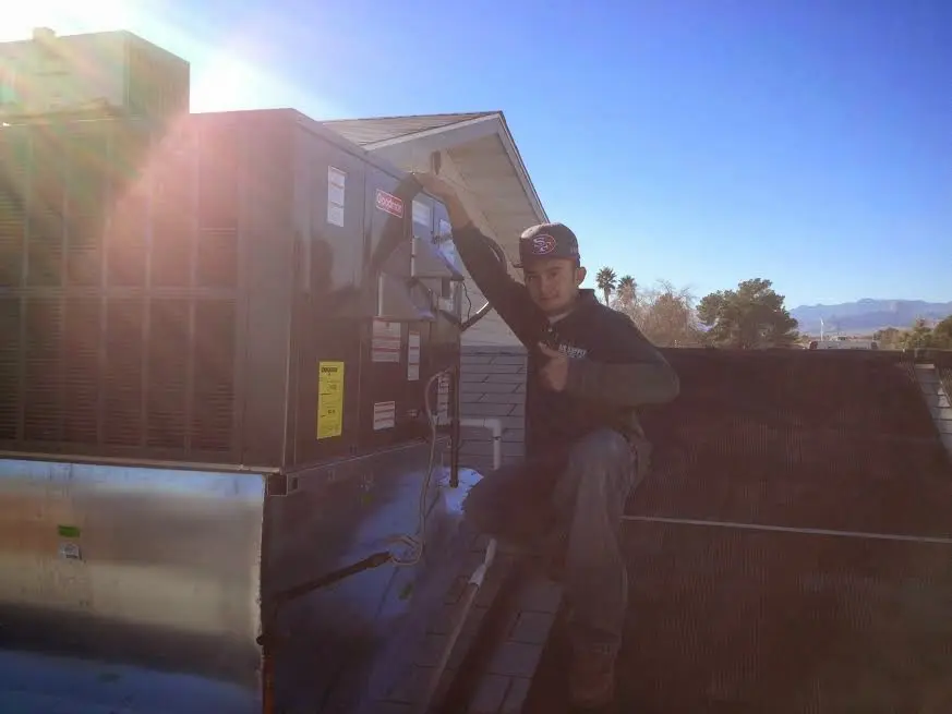 HVAC technician performing HVAC Inspection on a rooftop unit in River Road